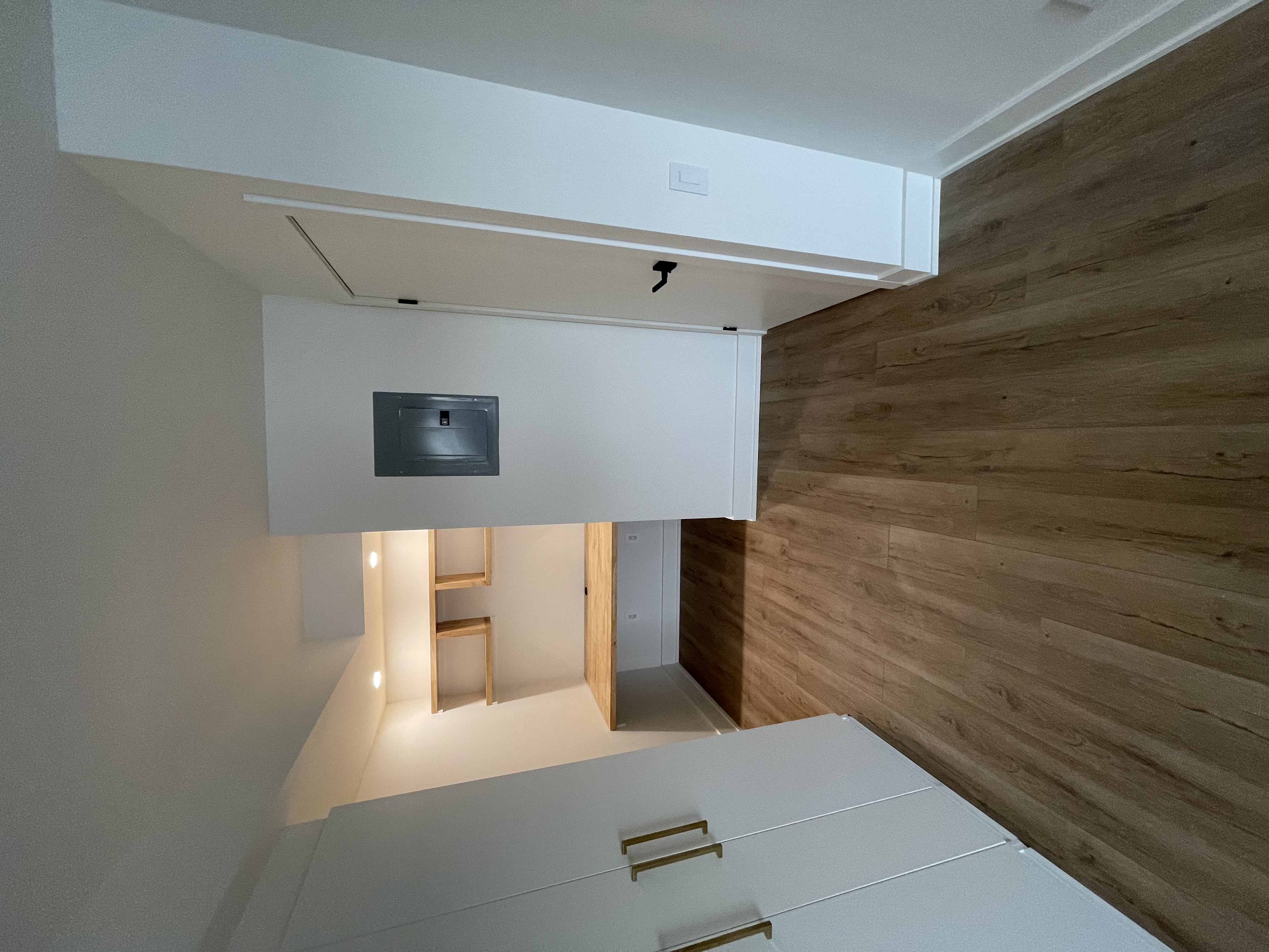 Clean finished basement with built-in desk area showing quality millwork and flooring — strong portfolio piece — Queensway, Hamilton | MTC Renovations