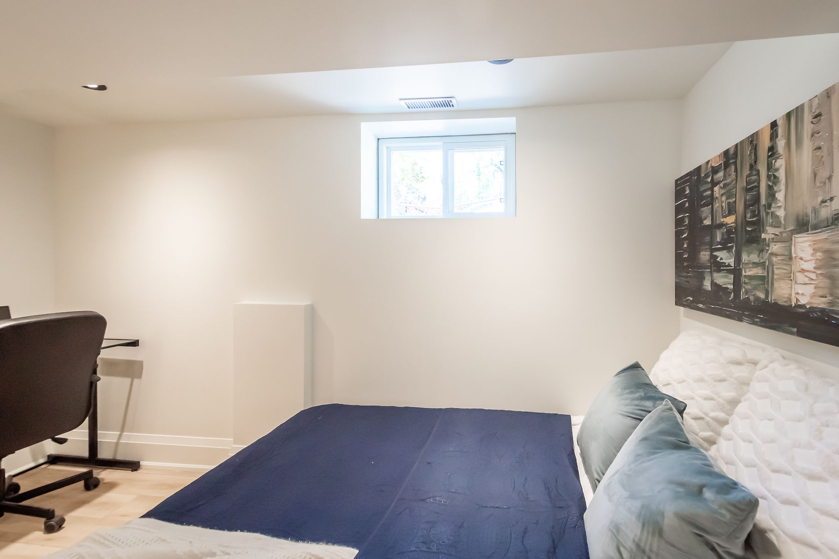 Clean finished basement with excellent natural light and professional staging — strong portfolio piece for basement renovations — Rosedene, Hamilton | MTC Renovations