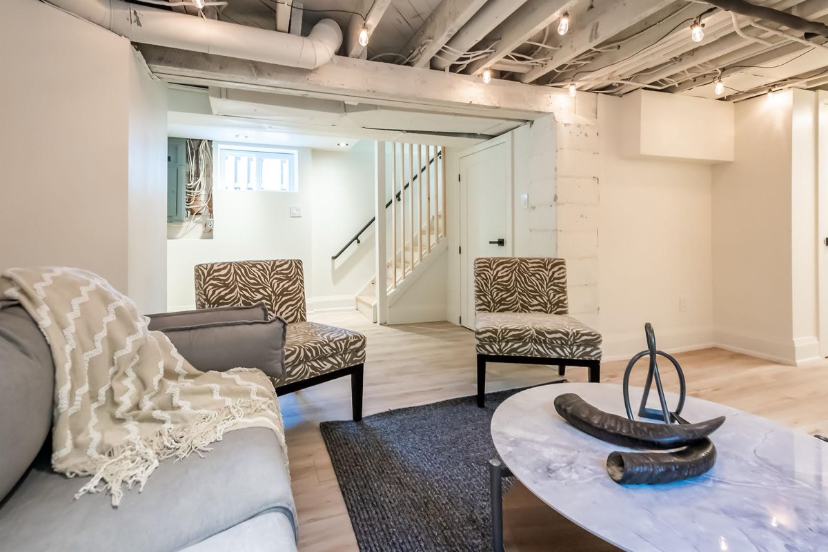 Beautifully finished basement with professional staging, warm lighting, and premium materials — excellent portfolio shot — Rosedene, Hamilton | MTC Renovations