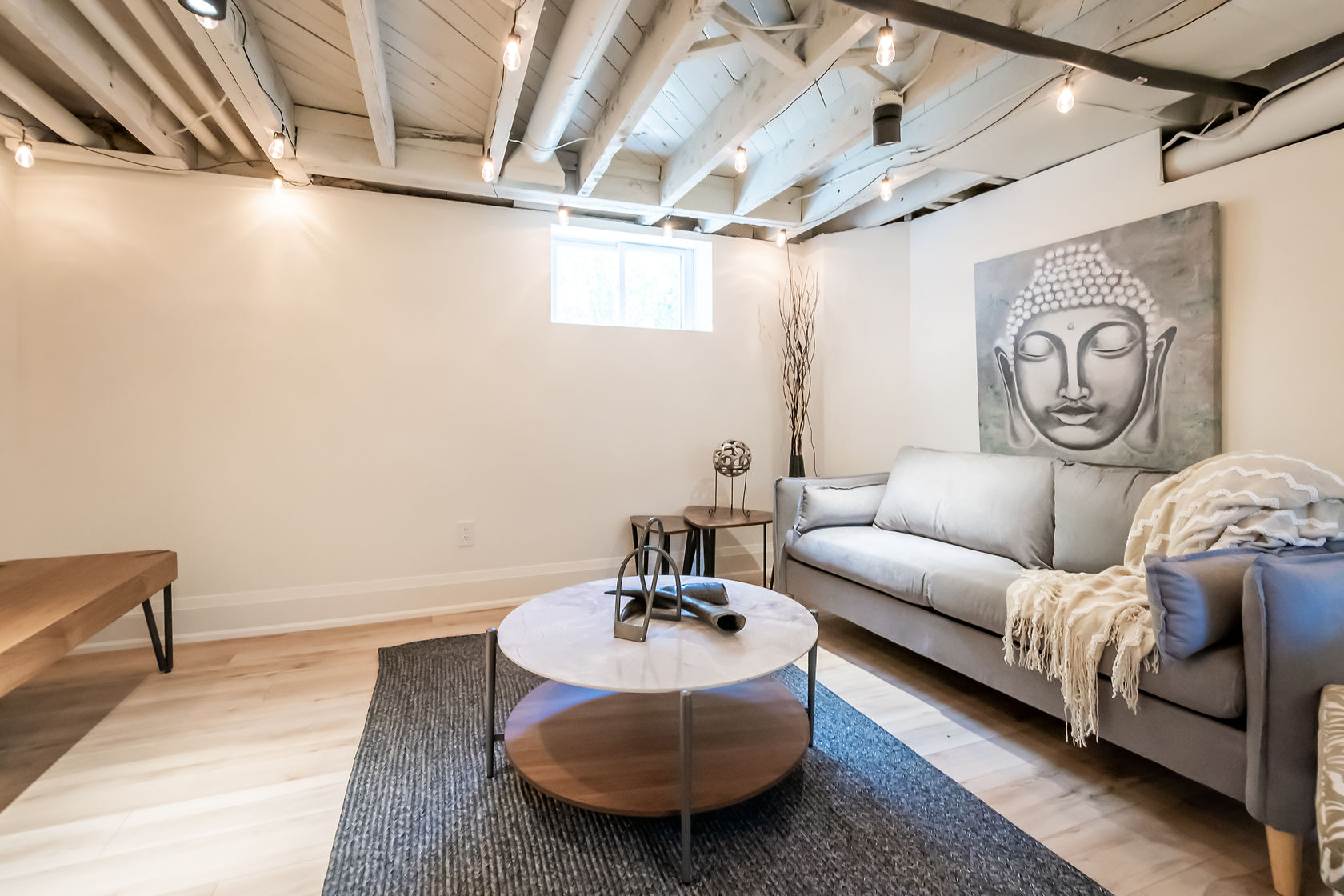 Beautifully finished basement with exposed beam ceiling, professional staging, and excellent lighting — premium portfolio shot — Rosedene, Hamilton | MTC Renovations