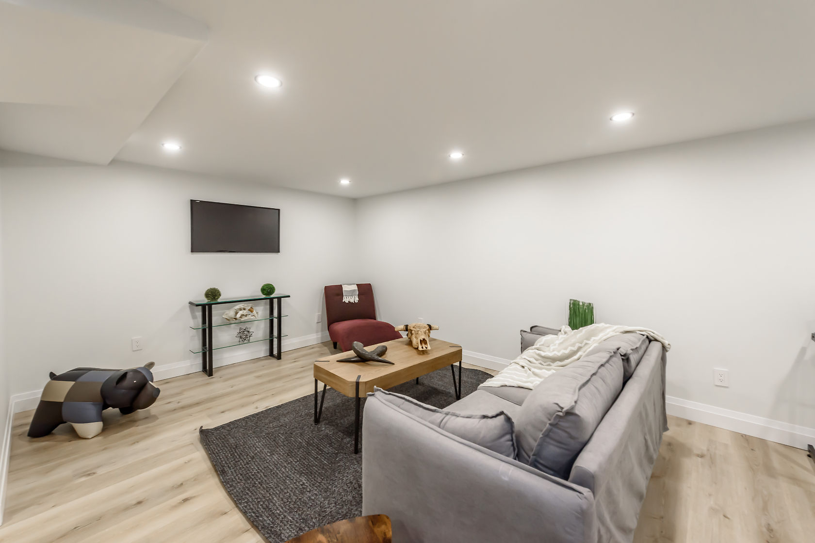 Clean finished basement with excellent lighting and staging — strong portfolio piece showing livable space transformation — Gateshead, Hamilton | MTC Renovations