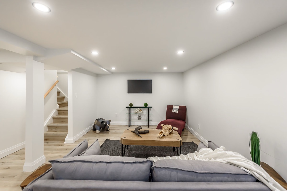 Bright finished basement with excellent staging and wide-angle composition — premium portfolio shot showing complete transformation — Gateshead, Hamilton | MTC Renovations