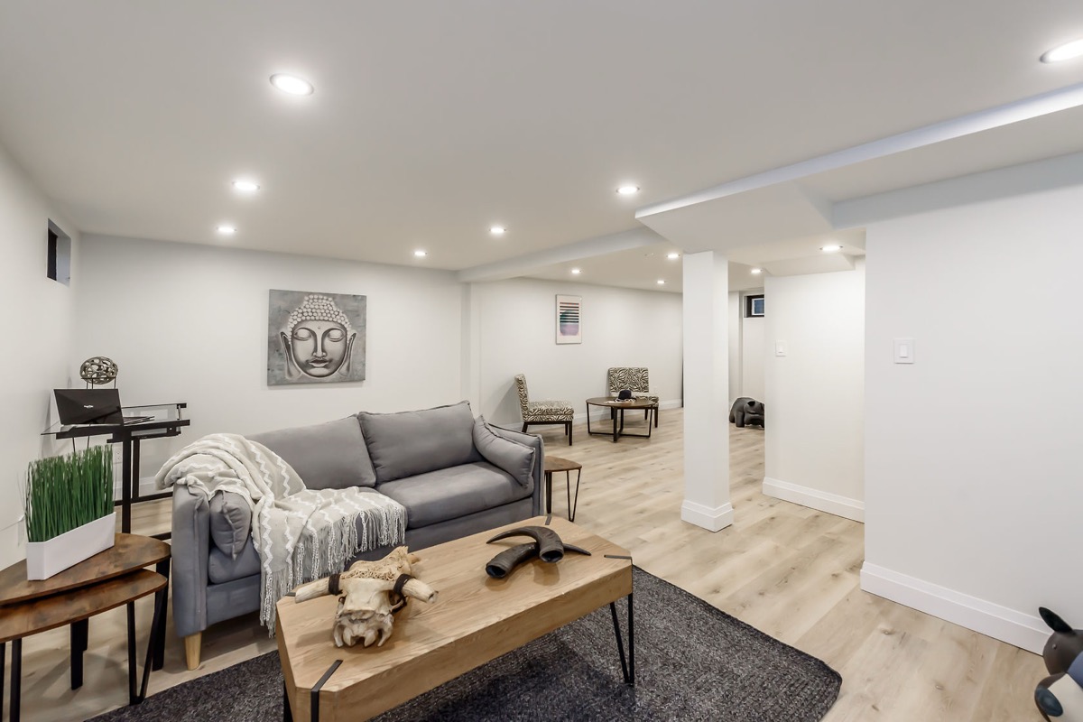 Beautifully finished basement with warm lighting, clean staging, and professional wide-angle composition — premium portfolio shot — Gateshead, Hamilton | MTC Renovations