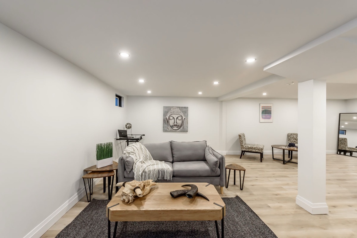 Beautifully finished basement with professional staging, warm lighting, and modern design — premium portfolio shot — Gateshead, Hamilton | MTC Renovations