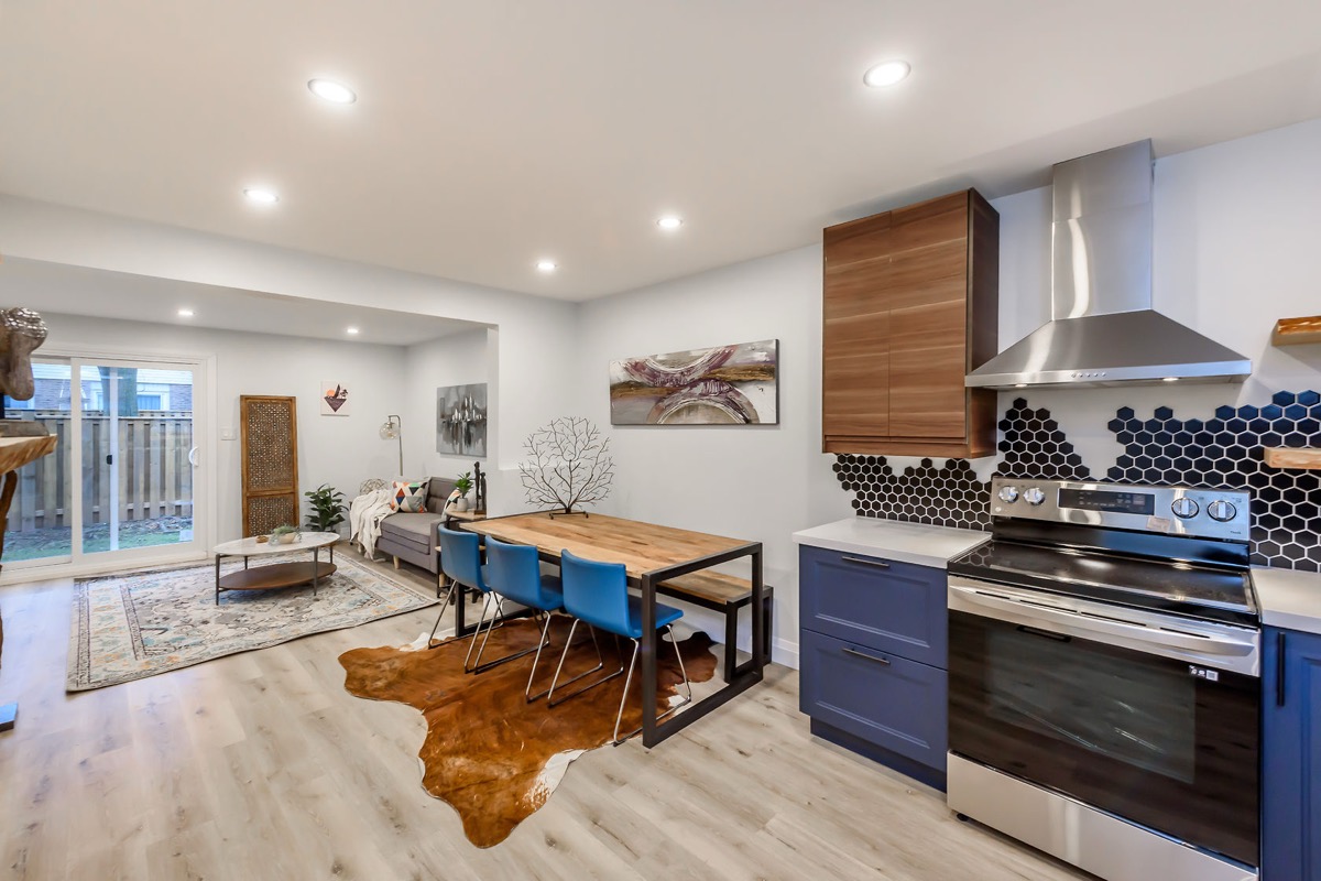 Modern kitchen renovation with blue cabinets and hexagon backsplash in Burlington